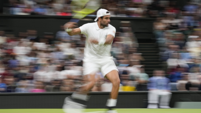 Matteo Berrettini of Italy plays a forehand return to compatriot Jannik Sinner during their second round match at the Wimbledon tennis championships in London, Wednesday, July 3, 2024. (AP Photo/Alberto Pezzali)