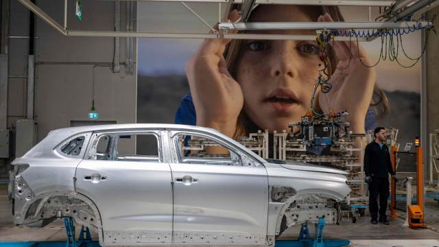 This photograph taken in Bursa on May 17, 2024 shows employees working on a car assembly line at a factory of Togg at the Gemlik Togg Technology Campus. Thousands of vehicles are rolling off its campus on the Sea of Marmara, built in less than two years. Already renowned for its car manufacturing, Turkey is showing its teeth in the electric car market with its champion, Togg. (Photo by Yasin AKGUL / AFP)
