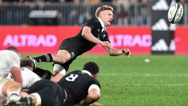 New Zealand's Damian McKenzie passes the ball during the rugby union Test match between the New Zealand All Blacks and England at Forsyth Barr Stadium in Dunedin on July 6, 2024. (Photo by Sanka Vidanagama / AFP)