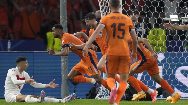 Cody Gakpo of the Netherlands, 2nd left, celebrates after scoring a goal, that was later considered as an own goal by Turkey's Mert Muldur, during a quarterfinal match between the Netherlands and Turkey at the Euro 2024 soccer tournament in Berlin, Germany, Saturday, July 6, 2024. (AP Photo/Ariel Schalit)