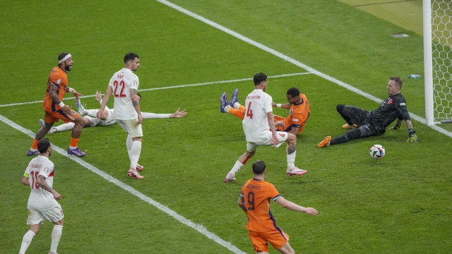 Cody Gakpo of the Netherlands, second right, scores a goal, that was later considered as an own goal by Turkey's Mert Muldur,during a quarterfinal match between the Netherlands and Turkey at the Euro 2024 soccer tournament in Berlin, Germany, Saturday, July 6, 2024. (AP Photo/Markus Schreiber)
