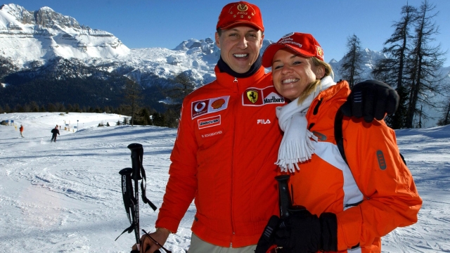 (FILES) Formula one World champion Ferrrari driver Michael Schumacher (L) poses in Madonna di Campiglio with his wife Corinna  16 January 2003. Two men accused of trying to blackmail relatives of Formula One legend Michael Schumacher had access to private family photos, German prosecutors said on July 3, 2024. Data records combed by investigators included "photo files relating to the Schumacher family's private life", the prosecutors in the western city of Wuppertal said in a statement. German authorities announced in June 2024 they had arrested a father and son on suspicion of trying to blackmail the Schumacher family. (Photo by Ercole COLOMBO / POOL / AFP)
