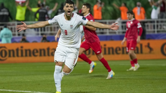 Iran's Mehdi Taremi celebrates after scoring his side's opening goal from a penalty spot during the Asian Cup Round of 16 soccer match between Iran and Syria, at Abdullah Bin Khalifa Stadium in Doha, Qatar, Wednesday, Jan. 31, 2024. (AP Photo/Aijaz Rahi)