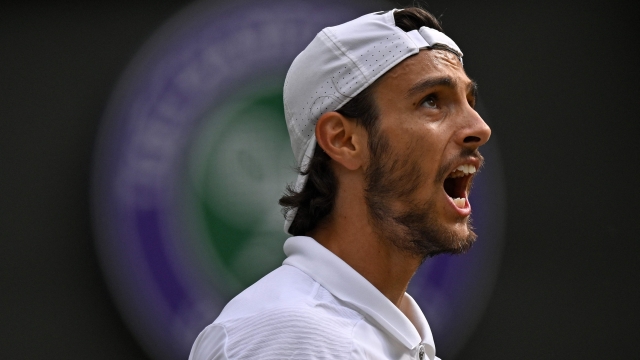 Italy's Lorenzo Musetti celebrates winning the third set against US player Taylor Fritz during their men's singles quarter-finals tennis match on the tenth day of the 2024 Wimbledon Championships at The All England Lawn Tennis and Croquet Club in Wimbledon, southwest London, on July 10, 2024. (Photo by ANDREJ ISAKOVIC / AFP) / RESTRICTED TO EDITORIAL USE