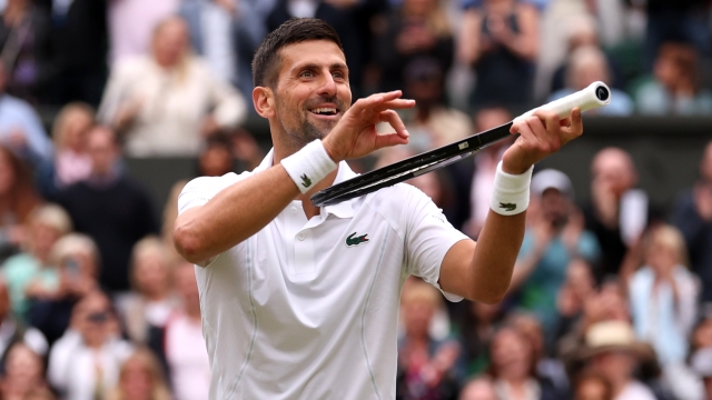LONDON, ENGLAND - JULY 12: Novak Djokovic of Serbia celebrates winning match point, with a violin gesture, against Lorenzo Musetti of Italy in the Gentlemen's Singles Semi-Final match during day twelve of The Championships Wimbledon 2024 at All England Lawn Tennis and Croquet Club on July 12, 2024 in London, England. (Photo by Julian Finney/Getty Images)