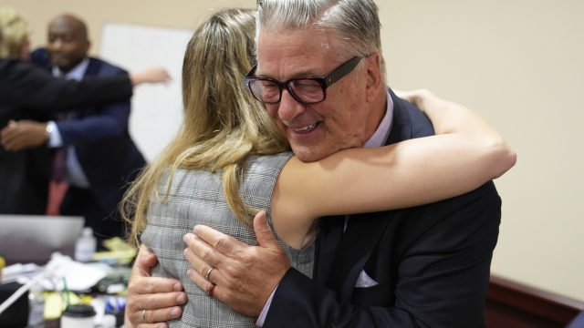 Actor Alec Baldwin hugs a member of his legal team after the judge threw out the involuntary manslaughter case for the 2021 fatal shooting of cinematographer Halyna Hutchins during filming of the Western movie "Rust," Friday, July 12, 2024, in Santa Fe, N.M. (Ramsay de Give/Pool Photo via AP)