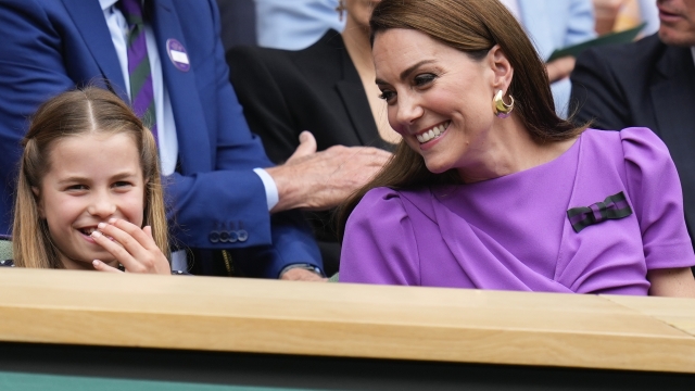 Kate, Princess of Wales and Princess Charlotte react on Centre Court ahead of the men's singles final at the Wimbledon tennis championships in London, Sunday, July 14, 2024. (AP Photo/Kirsty Wigglesworth)