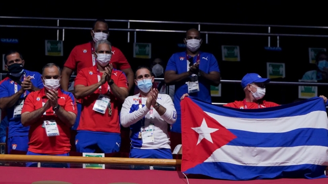 TOKYO, JAPAN - JULY 28: Team members of Cuba cheer during the Men's Feather (52-57kg) on day five of the Tokyo 2020 Olympic Games at Kokugikan Arena on July 28, 2021 in Tokyo, Japan. (Photo by Frank Franklin - Pool/Getty Images)