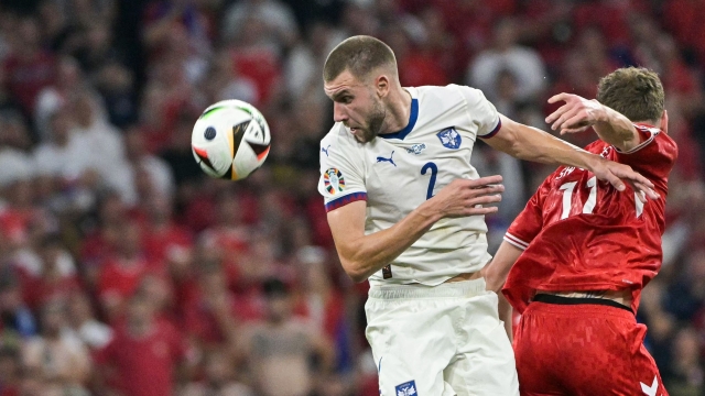 Serbia's defender #02 Strahinja Pavlovic heads the ball during the UEFA Euro 2024 Group C football match between Denmark and Serbia at the Munich Football Arena in Munich on June 25, 2024. (Photo by DAMIEN MEYER / AFP)