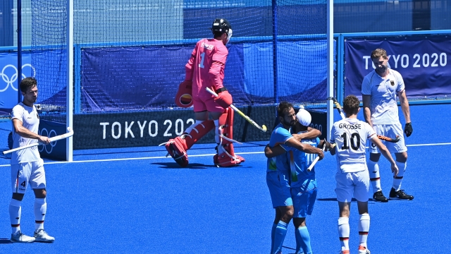 India's Simranjeet Singh (R) celebrates with a teammate after scoring against Germany during the men's bronze medal match of the Tokyo 2020 Olympic Games field hockey competition, at the Oi Hockey Stadium in Tokyo, on August 5, 2021. (Photo by Tauseef MUSTAFA / AFP)