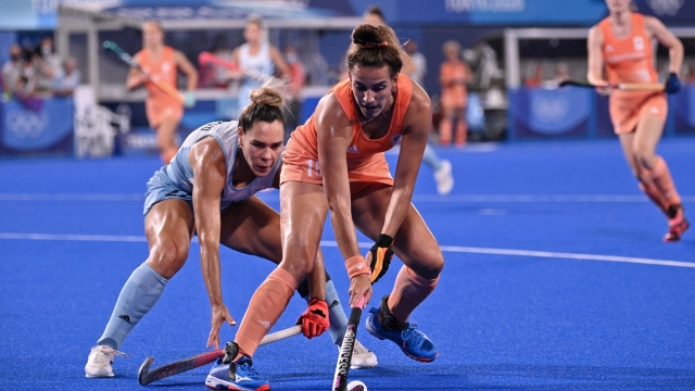Argentina's Maria Noel Barrionuevo (L) challenges Netherlands' Frederique Matla during the women's gold medal match of the Tokyo 2020 Olympic Games field hockey competition, at the Oi Hockey Stadium in Tokyo, on August 6, 2021. (Photo by Anne-Christine POUJOULAT / AFP)