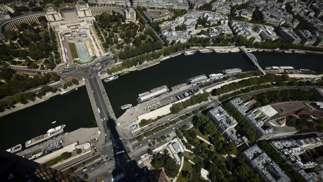 The Eiffel Tower casts its shadow on the Iena bridge, crossing the Seine river and leading to the Trocadero monument Tuesday, July 11, 2023 in Paris. In 2024, the Trocadero will offer a viewing platform for spectators for the triathlon, para triathlon, road cycling, athletics (marathon and 20km race walk) and swimming (10km marathon swimming) events. (AP Photo/Thomas Padilla, File)