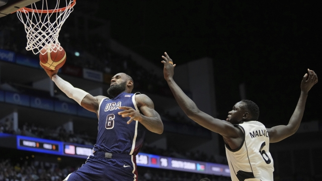 United States' forward LeBron James scores as South Sudan's center Khaman Maluach attempted top defend during an exhibition basketball game between the United States and South Sudan, at the o2 Arena in London, Saturday, July 20, 2024. (AP Photo/Kin Cheung)