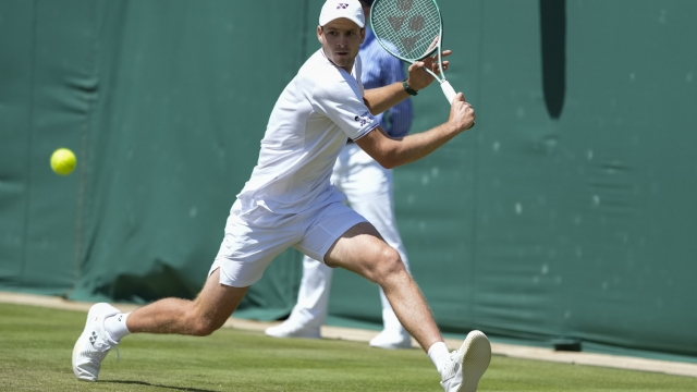 Hubert Hurkacz of Poland plays a backhand return to Arthur Fils of France during their second round match at the Wimbledon tennis championships in London, Thursday, July 4, 2024. (AP Photo/Mosa'ab Elshamy)