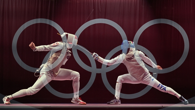 This multiple exposure picture show  Italy's Daniele Garozzo (R) compete against Egypt's Alaaeldin Abouelkassem in the mens team foil classification 5 - 8 bout during the Tokyo 2020 Olympic Games at the Makuhari Messe Hall in Chiba City, Chiba Prefecture, Japan, on August 1, 2021. (Photo by Fabrice COFFRINI / AFP)