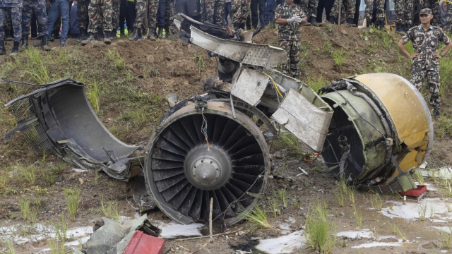 epa11493493 The wreckage of a plane crash as rescue operations are underway at Tribhuvan International Airport in Kathmandu, Nepal, 24 July 2024. According to a statement by the Civil Aviation Authority of Nepal (CAAN), a Saurya Airlines aircraft heading from Kathmandu to the resort town of Pokhara and carrying 19 people crashed during take off at Tribhuvan International Airport. The bodies of 18 people were recovered while one injured person was taken to hospital.  EPA/NARENDRA SHRESTHA