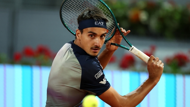 MADRID, SPAIN - APRIL 27: Lorenzo Sonego of Italy plays a backhand against Jannik Sinner of Italy in the Men's Singles Round of 64 match during Day Five of the Mutua Madrid Open at La Caja Magica on April 27, 2024 in Madrid, Spain. (Photo by Clive Brunskill/Getty Images)