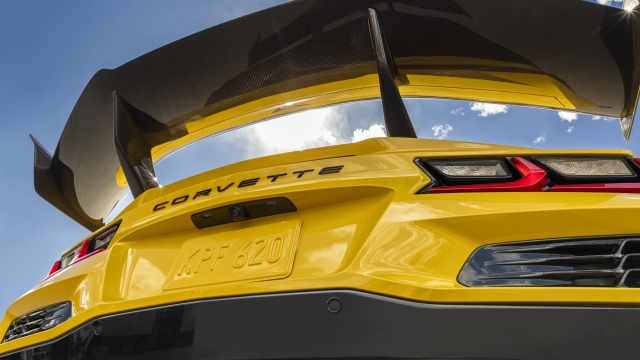 Rear view of Chevrolet Corvette ZR1 Coupe with ZTK Performance Package, looking up at the carbon fiber rear wing and blue sky. Preproduction model shown. Actual production model may vary.