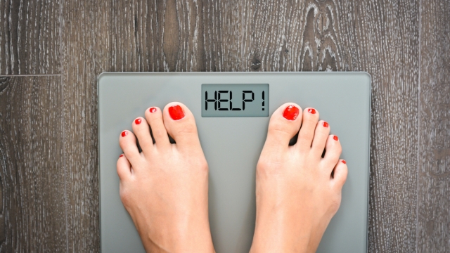 Lose weight concept with person on a scale measuring kilograms