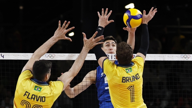 epa11498987 Alessandro Michieletto of Italy (C) spikes a ball during the Men Preliminary Round Pool B match Italy vs Brazil of the Volleyball competitions in the Paris 2024 Olympic Games, at the South Paris Arena in Paris, France, 27 July 2024.  EPA/MOHAMMED BADRA