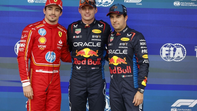 Red Bull driver Max Verstappen of the Netherlands, center, who clocked the fastest time, poses with Ferrari driver Charles Leclerc of Monaco, left, who clocked the second fastest time and Red Bull driver Sergio Perez of Mexico, who clocked the third fastest time during qualification ahead of the Formula One Grand Prix at the Spa-Francorchamps racetrack in Spa, Belgium, Saturday, July 27, 2024. The Belgian Formula One Grand Prix will take place on Sunday. (AP Photo/Geert Vanden Wijngaert)