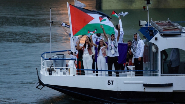 Athletes from the Palestine delegation sail in a boat along the river Seine during the opening ceremony of the Paris 2024 Olympic Games in Paris on July 26, 2024. (Photo by Luis TATO / AFP)
