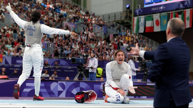 epa11502856 Laureen Scruggs (L) of the USA celebrates after beating Arianna Errigo of Italy in the Women Foil Individual Round of 8 in the Paris 2024 Olympic Games, at the Grand Palais in Paris, France, 28 July 2024.  EPA/RITCHIE B. TONGO