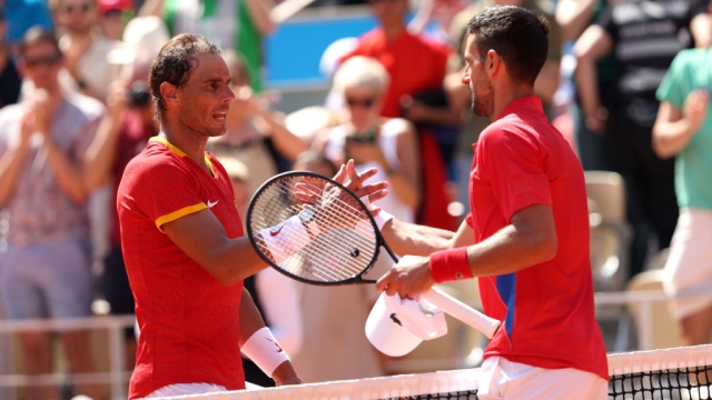 PARIS, FRANCE - JULY 29: Winner Novak Djokovic of Team Serbia (R) is congratulated by Rafael Nadal of Team Spain after the Men's Singles second round match on day three of the Olympic Games Paris 2024 at Roland Garros on July 29, 2024 in Paris, France. (Photo by Clive Brunskill/Getty Images)