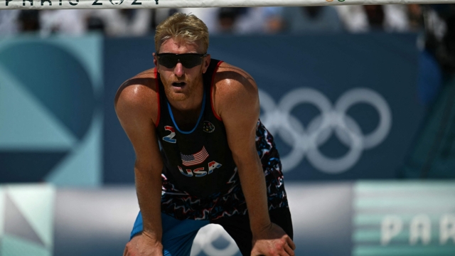 US' #02 Chase Budinger waits for the ball in the men's pool F beach volleyball match between France and USA during the Paris 2024 Olympic Games at the Eiffel Tower Stadium in Paris on July 29, 2024. (Photo by Mauro PIMENTEL / AFP)