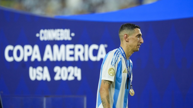 Argentina's Angel Di Maria walks with his champion medal after beating Colombia in the Copa America final soccer match in Miami Gardens, Fla., Monday, July 15, 2024. (AP Photo/Rebecca Blackwell)