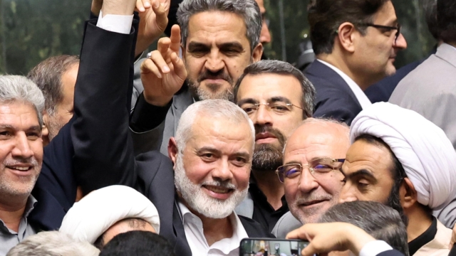 epa11510676 Hamas political leader Ismail Haniyeh (C) flashes victory sign as surrounded by Iranian lawmakers at the Iranian parliament in Tehran, Iran, 30 July 2024 (issued 31 July 2024). According to an Iranian Revolutionary Guard Corps (IRGC) statement on 31 July 2024, Haniyeh and one of his bodyguards were targeted and killed in Tehran on 31 July 2024.  EPA/ABEDIN TAHERKENAREH