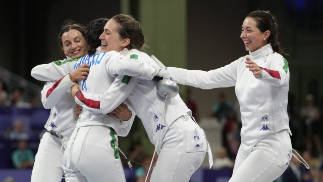 Italy's Alberta Santuccio, left, celebrates with her teammate Rossella Fiamingo, centre, Giulia Rizzi and Mara Navarria, right, after winning the women's team Epee semifinal match against China during the 2024 Summer Olympics at the Grand Palais, Tuesday, July 30, 2024, in Paris, France. (AP Photo/Andrew Medichini)