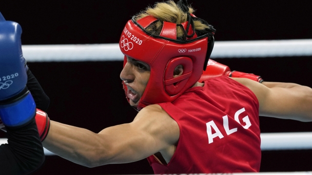 FILE - Imane Khelif, of Algeria, right, delivers a punch to Mariem Homrani Ep Zayani, of Turkey, during their women's light weight 60kg preliminary boxing match at the 2020 Summer Olympics, Friday, July 30, 2021, in Tokyo, Japan. (AP Photo/Themba Hadebe, File)