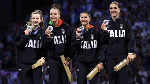 PARIS, FRANCE - AUGUST 01: Silver medalists of Team Italy celebrate on the podium during the Women's Foil Team medal ceremony  on day six of the Olympic Games Paris 2024 at Grand Palais on August 01, 2024 in Paris, France. (Photo by Clive Brunskill/Getty Images)