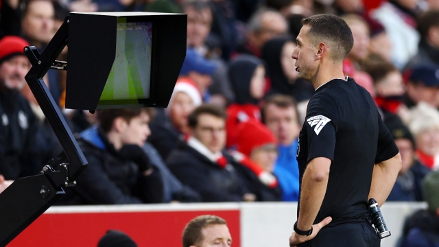 BRENTFORD, ENGLAND - DECEMBER 17: Referee David Coote
refers to the on-field VAR screen before showing a red card to Ben Mee of Brentford during the Premier League match between Brentford FC and Aston Villa at Gtech Community Stadium on December 17, 2023 in Brentford, England. (Photo by Clive Rose/Getty Images)