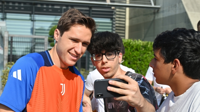 TURIN, ITALY - JULY 23: Federico Chiesa of Juventus FC greets fans and takes photos and signs autographs after he arrives for medical tests and first day back in training on July 23, 2024 in Turin, Italy. (Photo by Chris Ricco - Juventus FC/Juventus FC via Getty Images)