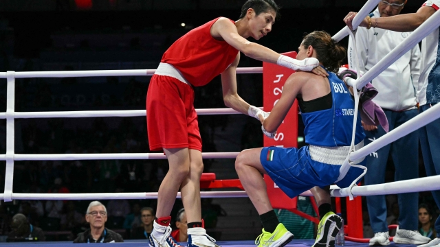 Taiwan's Lin Yu-ting reacts after beating Bulgaria's Svetlana Kamenova Staneva (Blue) in the women's 57kg quarter-final boxing match during the Paris 2024 Olympic Games at the North Paris Arena, in Villepinte on August 4, 2024. (Photo by MOHD RASFAN / AFP)