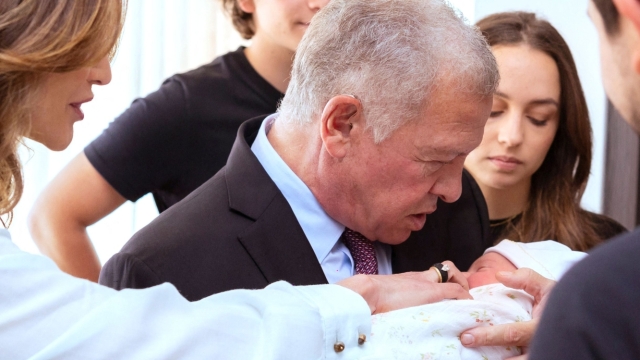 This handout picture released on August 3 by the Jordanian Royal Palace shows Jordan's King Abdullah II (C) holding his their newborn granddaughter Iman next to his wife Queen Rania (L) in Amman. Saudi Princess Rajwa, wife of Crown Prince Hussein of Jordan, gave birth to a daughter, the royal couple's first child on August 3, the Jordanian Royal Court said in a statement. (Photo by Jordanian Royal Palace / AFP) / RESTRICTED TO EDITORIAL USE - MANDATORY CREDIT "AFP PHOTO / JORDANIAN ROYAL PALACE / YOUSEF ALLAN" - NO MARKETING NO ADVERTISING CAMPAIGNS - DISTRIBUTED AS A SERVICE TO CLIENTS