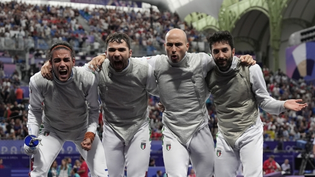 Italy's fencers Guillaume Bianchi, Filippo Macchi, Tommaso Marini and Alessio Foconi celebrate after winning the men's team foil semifinal match against United States during the 2024 Summer Olympics at the Grand Palais, Sunday, Aug. 4, 2024, in Paris, France. (AP Photo/Andrew Medichini)