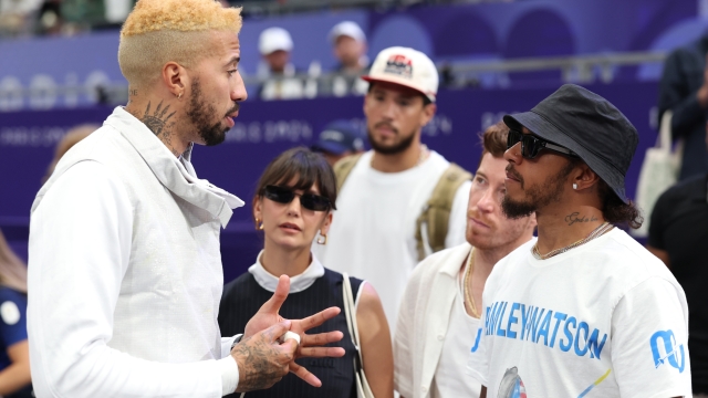 PARIS, FRANCE - AUGUST 04: Miles Chamley-Watson of Team Team United States interacts with Lewis Hamilton as Shaun White and Nina Dobrev look on during the Men's Foil Team semifinal between Team Italy and Team United States on day nine of the Olympic Games Paris 2024 at Grand Palais on August 04, 2024 in Paris, France. (Photo by Ezra Shaw/Getty Images)