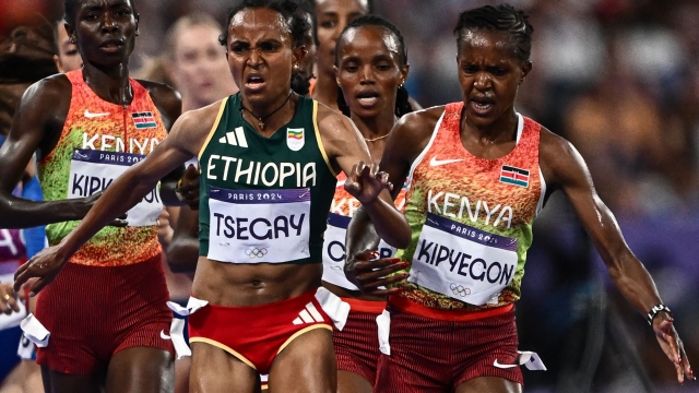 Kenya's Faith Kipyegon and Ethiopia's Gudaf Tsegay compete in the women's 5000m final of the athletics event at the Paris 2024 Olympic Games at Stade de France in Saint-Denis, north of Paris, on August 5, 2024. (Photo by Jewel SAMAD / AFP)