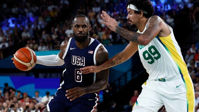 USA's #06 LeBron James challenges Brazil's #99 Lucas Dias in the men's quarterfinal basketball match between Brazil and the USA during the Paris 2024 Olympic Games at the Bercy  Arena in Paris on August 6, 2024. (Photo by Luis TATO / AFP)