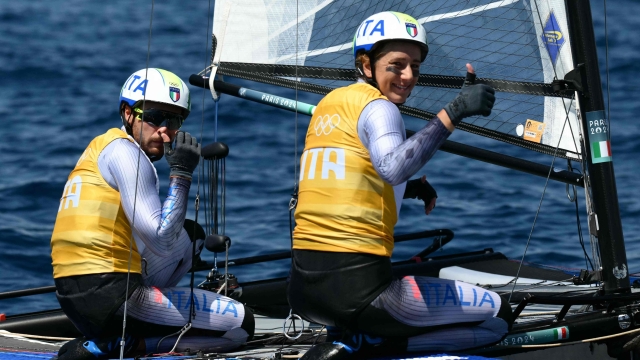 Italy's duo Ruggero Tita and Catarina Marianna Banti react after winning race 7 of the mixed Nacra 17 multihull event during the Paris 2024 Olympic Games sailing competition at the Roucas-Blanc Marina in Marseille on August 5, 2024. (Photo by Christophe SIMON / AFP)