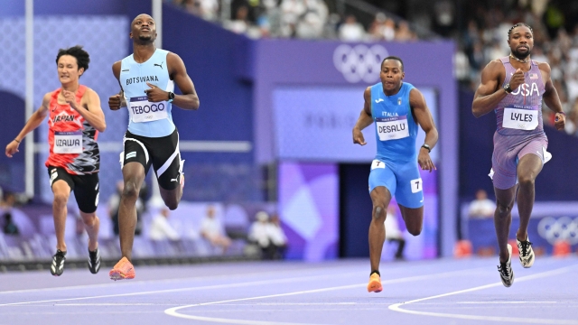 Botswana's Letsile Tebogo (2L) crosses the finish line ahead of US' Noah Lyles (R), Japan's Towa Uzawa and Italy's Eseosa Fostine Desalu in the men's 200m semi-final of the athletics event at the Paris 2024 Olympic Games at Stade de France in Saint-Denis, north of Paris, on August 7, 2024. (Photo by Jewel SAMAD / AFP)