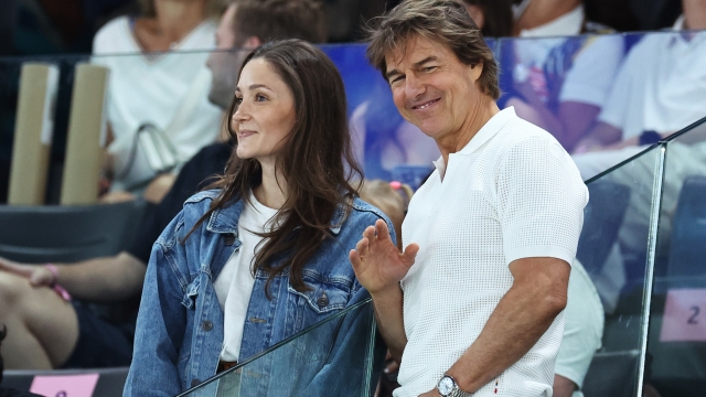 PARIS, FRANCE - JULY 28: Tom Cruise (R) waves during the Artistic Gymnastics Women's Qualification on day two of the Olympic Games Paris 2024 at Bercy Arena on July 28, 2024 in Paris, France. (Photo by Arturo Holmes/Getty Images)