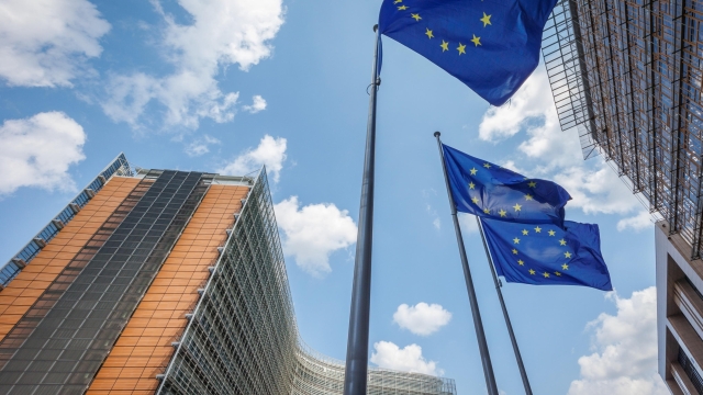 epa11483897 European Union flags flutter in front of the European Commission Berlaymont building (L), in Brussels, Belgium, 17 July 2024. The European Parliament is scheduled to vote on 18 July on Ursula von der Leyen's second term as EU Commission President.  EPA/OLIVIER MATTHYS