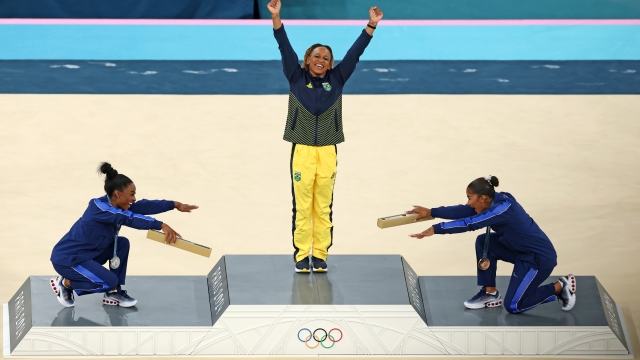 PARIS, FRANCE - AUGUST 05: Gold medalist Rebeca Andrade (C) of Team Brazil, silver medalist Simone Biles (L) of Team United States and bronze medalist Jordan Chiles (R) of Team United States celebrate on the podium at the Artistic Gymnastics Women's Floor Exercise Medal Ceremony on day ten of the Olympic Games Paris 2024 at Bercy Arena on August 05, 2024 in Paris, France. (Photo by Elsa/Getty Images) *** BESTPIX ***