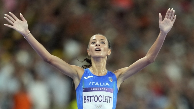 Nadia Battocletti, of Italy, celebrates after winning the silver medal in the women's 10000 meters final at the 2024 Summer Olympics, Friday, Aug. 9, 2024, in Saint-Denis, France. (AP Photo/Ashley Landis)