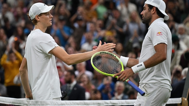 Italy's Matteo Berrettini (R) congratulates Italy's Jannik Sinner on winning their men's singles second round tennis match on the third day of the 2024 Wimbledon Championships at The All England Lawn Tennis and Croquet Club in Wimbledon, southwest London, on July 3, 2024. Sinner won the Match 7-6, 7-6, 2-6, 7-4. (Photo by ANDREJ ISAKOVIC / AFP) / RESTRICTED TO EDITORIAL USE