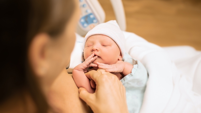 New born baby in hospital bed, child birth, and new life concept.